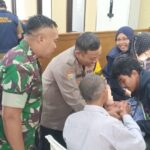 Bhabinkamtibmas Bersinergi Dengan Babinsa Hadiri Sunatan Massal Di DPC LDII KOTABARU